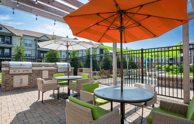 a patio with tables chairs and umbrellas