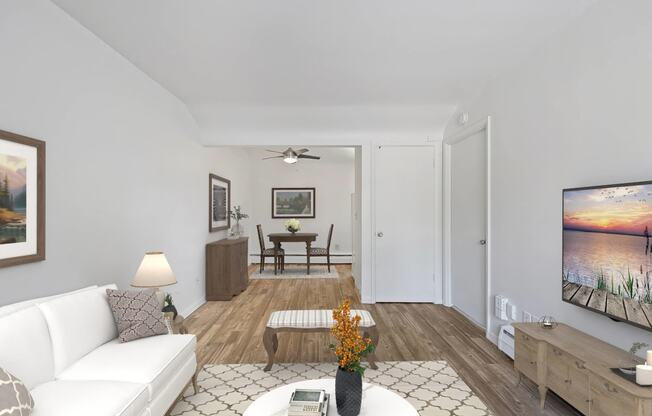 a living room with a white couch and a tv