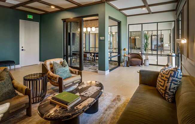 A living room with a brown couch, a coffee table, and a glass door.
