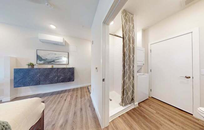 A bedroom with a bed, a dresser, and a painting on the wall.