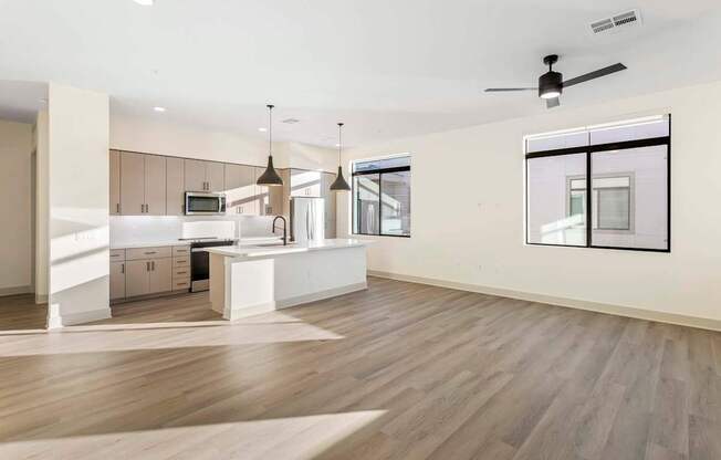 A modern kitchen with a dining area and a living room.