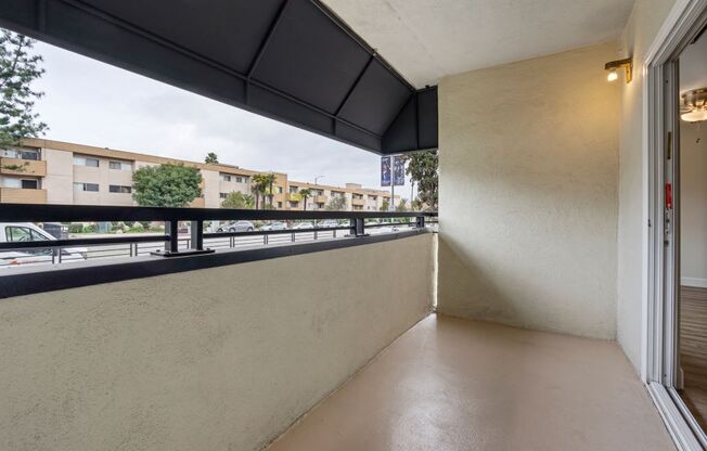 a balcony with a view of the street and buildings