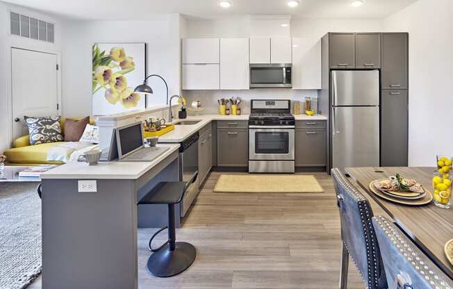 a kitchen and dining room with stainless steel appliances and a table