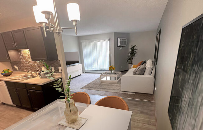 a kitchen and living room with a white table and chairs