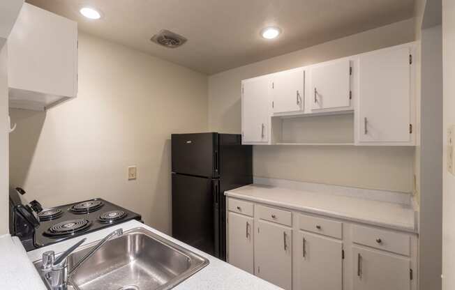 This is a photo the kitchen with white cabinets in the 925 square foot, Hazelnut 2 bedroom, 1 bath apartment at Montana Valley Apartments in the Westwood neighborhood of Cincinnati, OH.