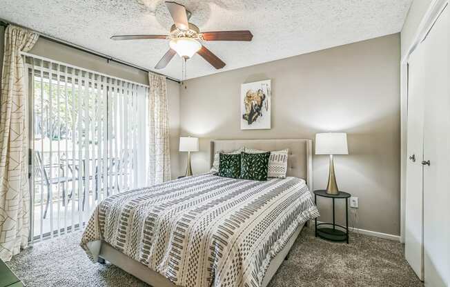 a bedroom with a bed and a ceiling fan