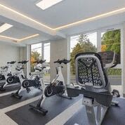 Fitness Center with Cardio Equipment and Views outside of trees at Arabella Apartment Homes, Shoreline, 98155