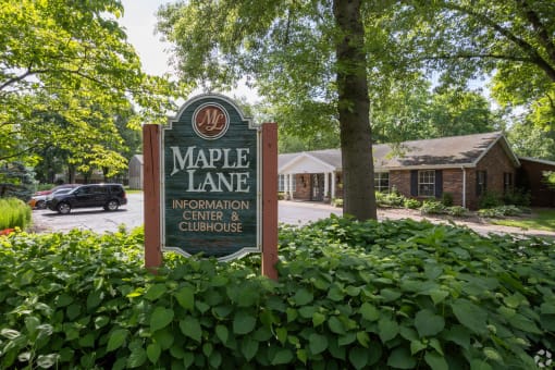 a sign for maple lane in front of a building