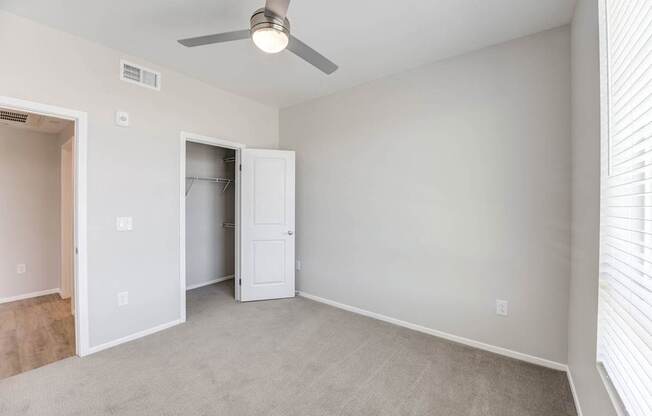 a bedroom with gray walls and a ceiling fan at The Overlook Santa Clarita, CA 91350
