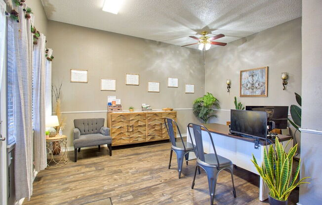 a living room with a desk and a tv