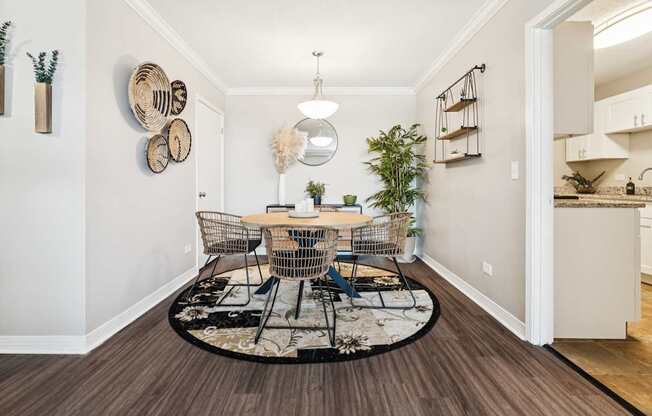 A dining room with a round table and chairs.