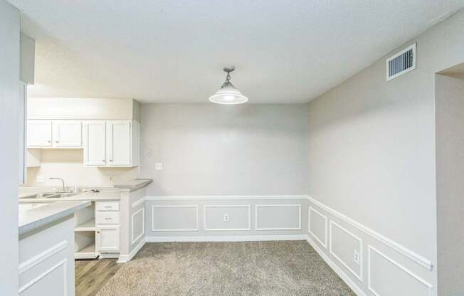 A kitchen with white cabinets and a countertop.