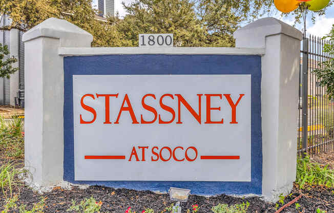 a sign in front of a fence