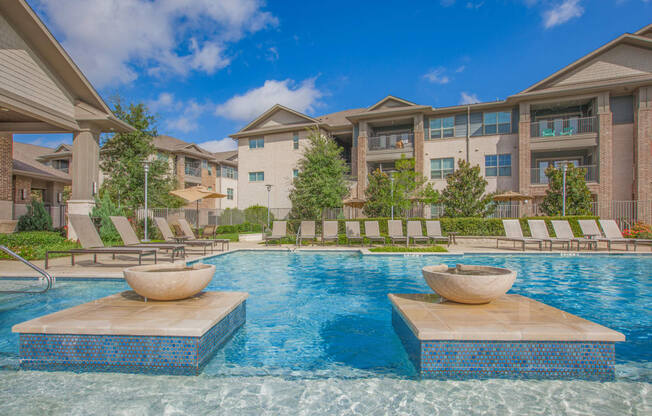pool with apartment building at Ovation at Lewisville Apartments, Lewisville, Texas
