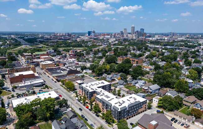A cityscape with a mix of residential and commercial buildings under a clear sky.