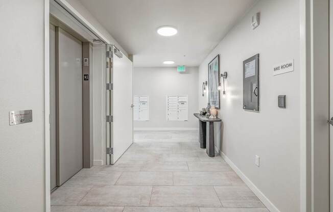 a hallway with a door at the end and a counter on the side of the hallway