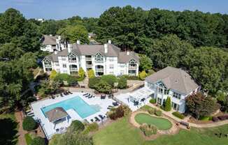A large white house with a pool in the backyard.