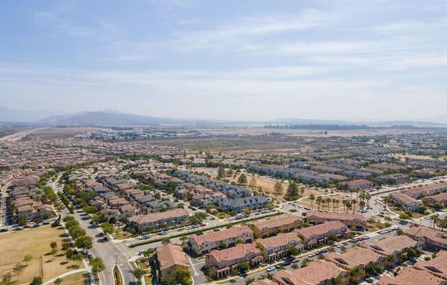 an aerial view of a city with houses and a highway at The Vines at Riverpark, LLC, California