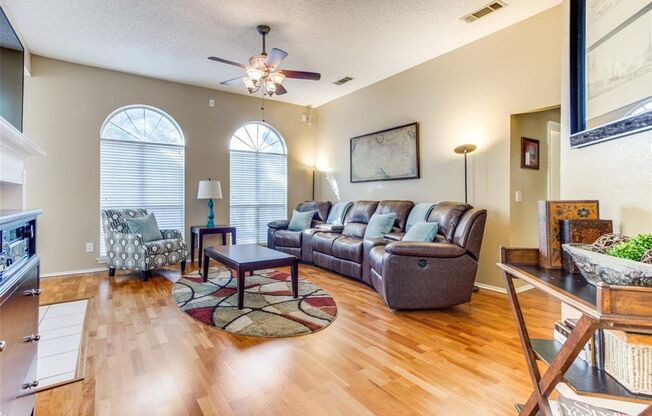 This charming 3-bedroom, 2-bath home in Frisco, TX, boasts elegant hardwood floors throughout, enhancing its warm and inviting atmosphere.