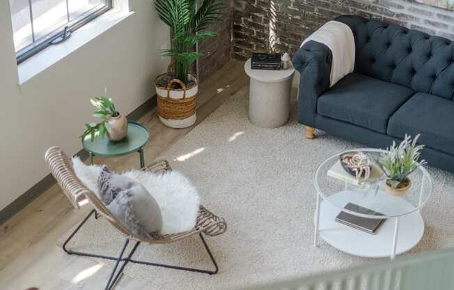 a living room filled with furniture and a large window at The 22 Apartments, St. Louis Missouri