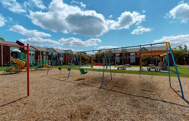 a playground with a swing set and other playground equipment