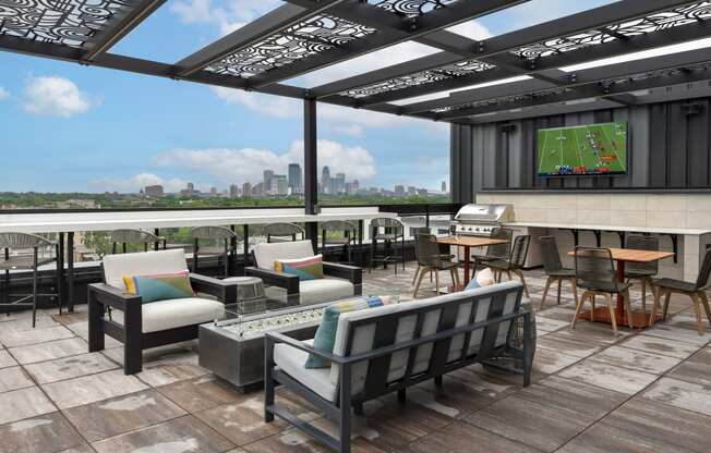 a rooftop patio with a tennis court and a view of the cityat The Bohen Apartments , Minnesota, 55408