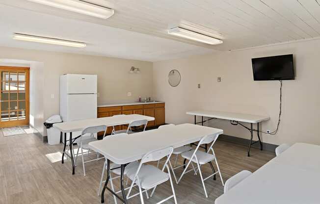 a dining room with tables and chairs and a television