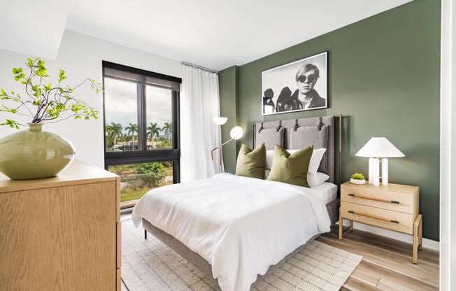 Create your dream bedroom at Modera Aventura, where warm finishes, natural light, and palm-lined views create a relaxed, inviting retreat.