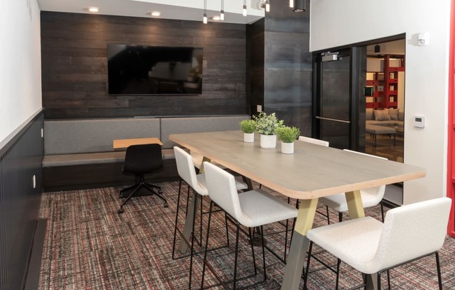 a dining room with a table and chairs and a tv