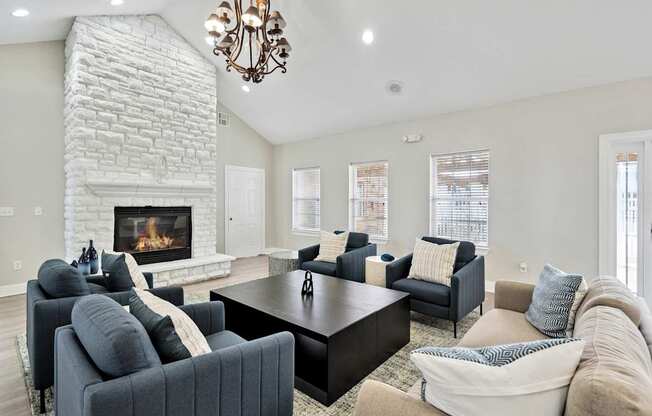 A living room with a fireplace and a chandelier.
