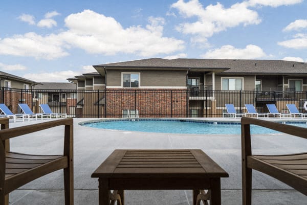 Resort-style pool with lounge seating at The Villas at Falling Waters townhomes for rent in West Omaha NE