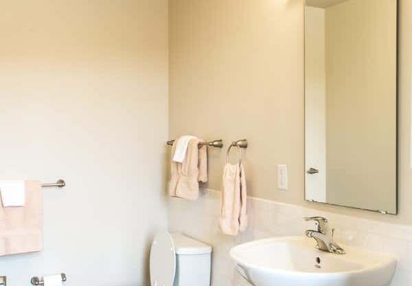 A white toilet and sink in a bathroom.