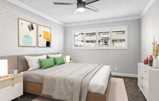 Carpeted bedroom with ceiling fan.