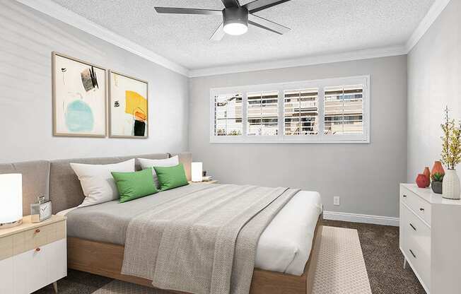 Carpeted bedroom with ceiling fan.