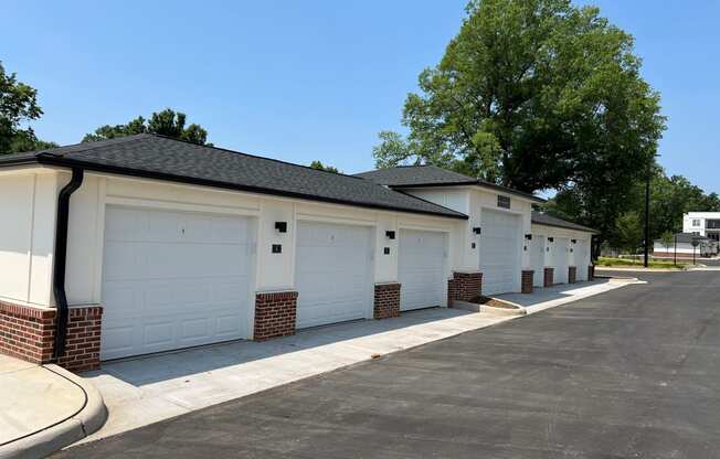 a row of garages in front of trees