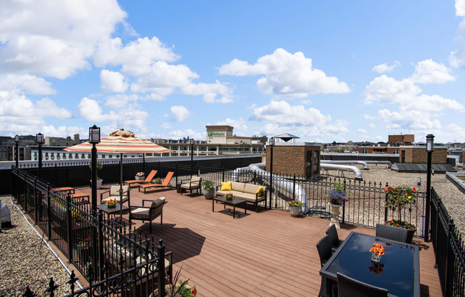 a roof deck with furniture and a view of the city
