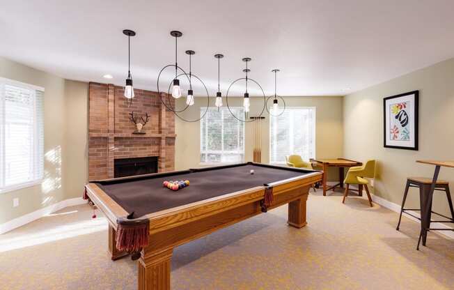a living room with a pool table and a fireplace