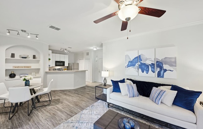 a living room with a couch and a ceiling fan