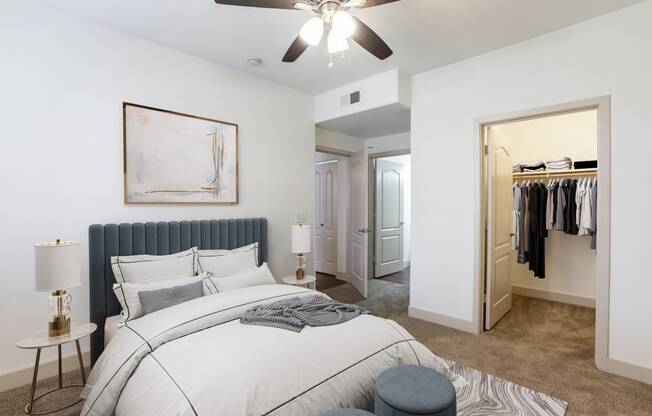 a bedroom with a large bed and a ceiling fan