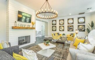 a living room with a fireplace and a chandelier