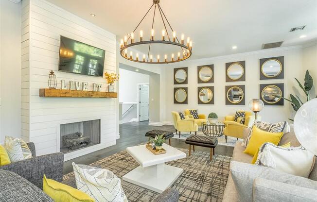 a living room with a fireplace and a chandelier