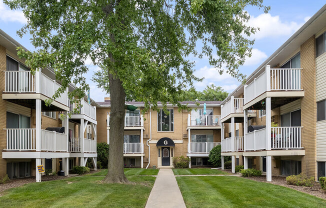 our apartments have a spacious courtyard with green grass and trees