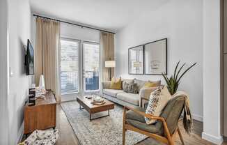 A living room with seating and a tv