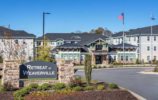 the view of retreat at weaverville with a sign in front of a building