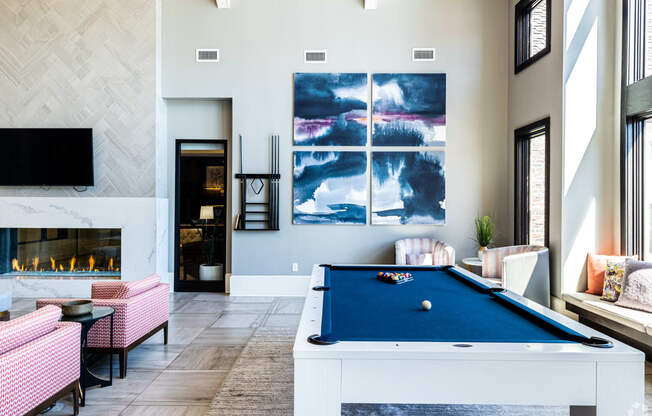 an open living room with a pool table and a fireplace