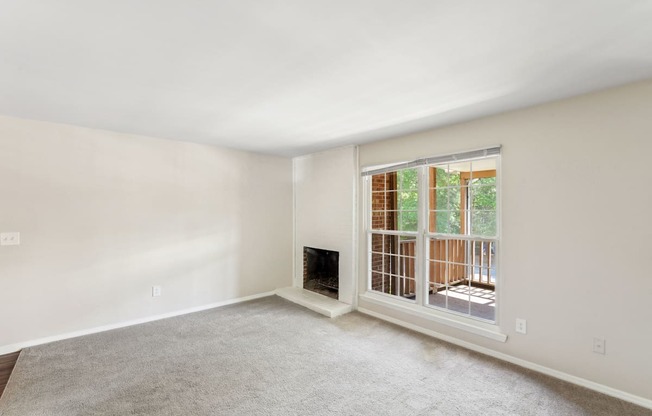 a living room with a fireplace and a large window