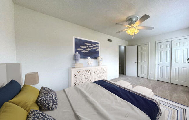 a bedroom with a bed and a ceiling fan