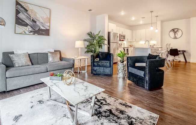 a living room with couches and chairs and a table