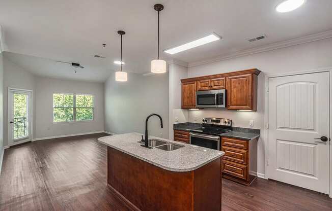 a kitchen with wooden cabinets and a granite counter top