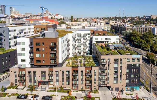 a building with a green roof and a city in the background